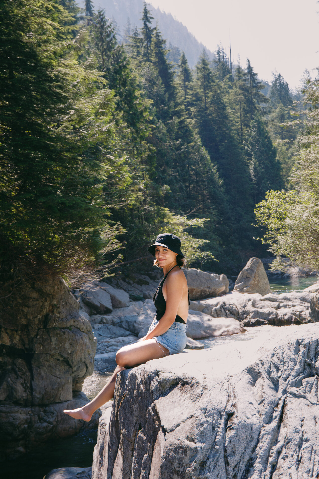 Happy Hiker sitting on a rock at Widgeon Falls in BC